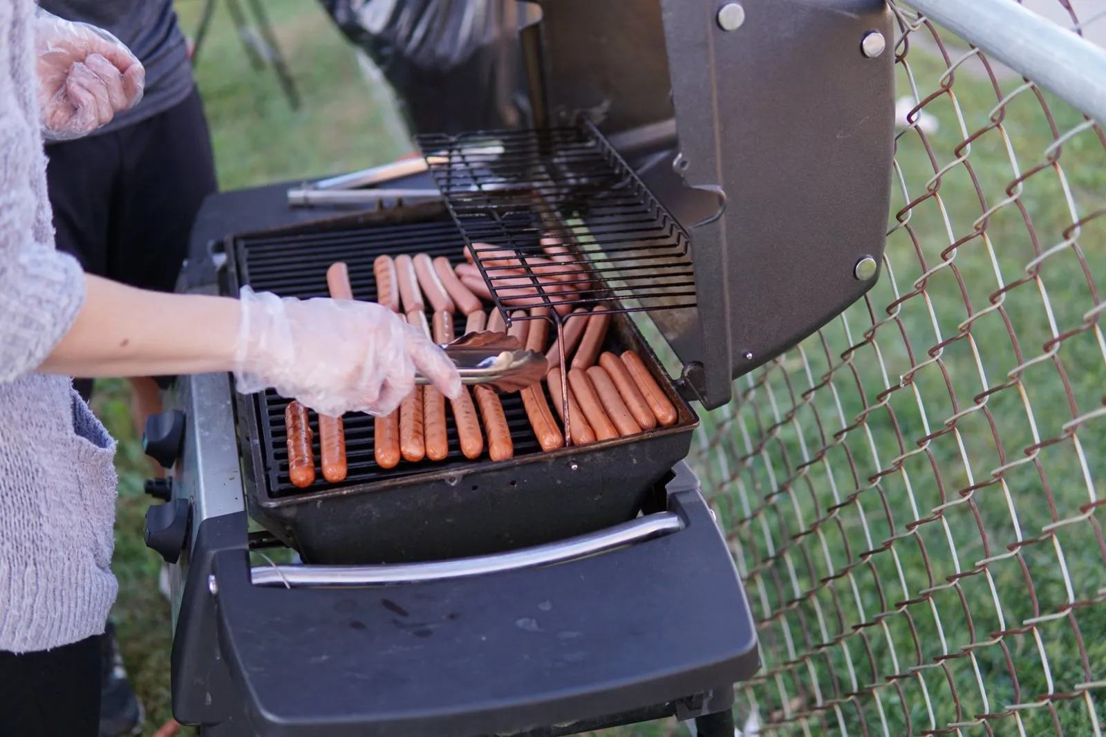 Grilling hot dogs at the community barbeque